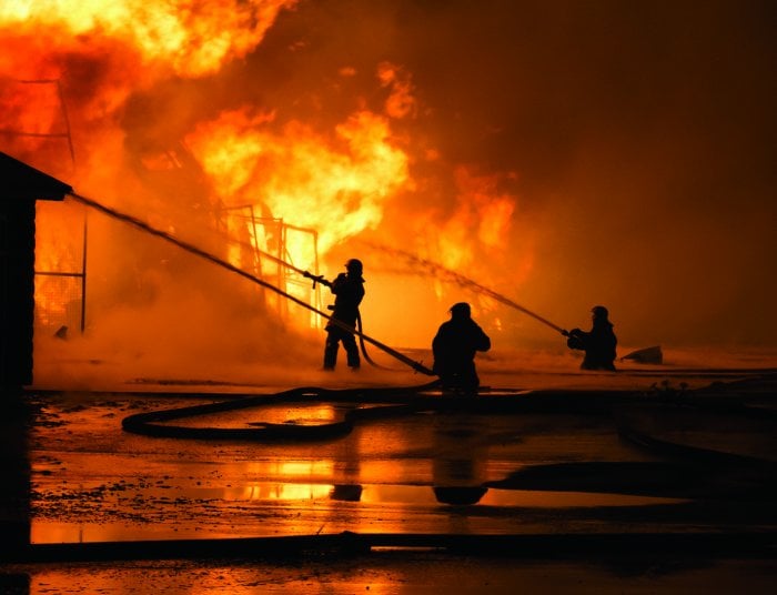 Firefighters battling blaze with hoses